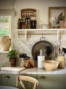 a kitchen with a counter with bowls and other items on it at Plum Henley in Henley