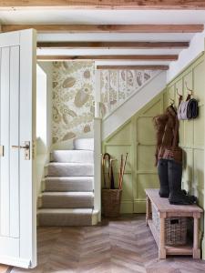 a staircase in a house with green walls at Plum Henley in Henley