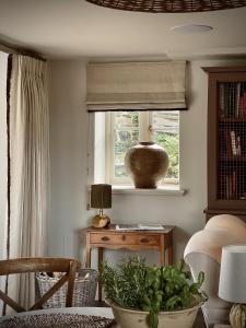 Henley的住宿－Plum Henley，客厅设有窗户和植物桌子