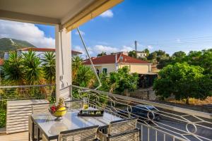 a balcony with a table and chairs and a view at VICANTI Luxury Apartments in Pylos