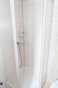 a bathroom with a shower with a toilet and a sink at Majerik Hotel in Hévíz