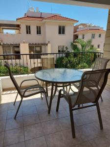 a table and chairs on a patio with a view of a building at Pyla Palms A2 107 in Pyla
