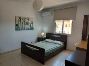 a bedroom with a bed and a window at Pyla Palms A2 107 in Pyla