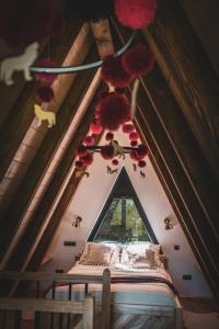 a room with a bed in a attic with a window at Grzechatka in Wetlina