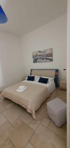 a bedroom with a large bed and a tile floor at Gentilcasa in Monopoli