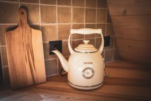 a white electric tea kettle next to a cutting board at Grzechatka in Wetlina