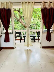 a room with red curtains and a tiled floor at SkyView Villa in Candolim