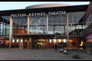 a large building with a sign that reads million keynes theatre at Stunning 1-Bed Apartment in Milton Keynes in Milton Keynes