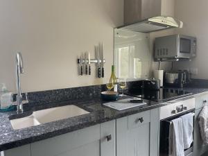 a kitchen with a sink and a counter top at The Old Coach House in Redlynch