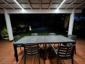 a black table and chairs on a patio at night at TENUTA FERRARI in Cortile +12 photos