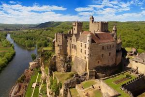 an aerial view of a castle next to a river at Maison Calme au Cœur du Périgord Noir - 3 Chambres in Le Bugue