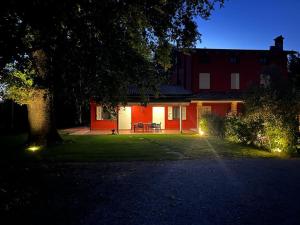a house with a tree and lights in the yard at TENUTA FERRARI in Cortile