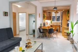 a living room with a couch and a table at Cozy Central Home Heraklion in Heraklio