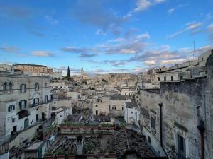 a view of the city from the roofs of buildings at La Suite Matera Hotel & Spa in Matera