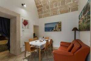 a living room with a dining room table and chairs at Suite Paisiello in Lecce +20 photos