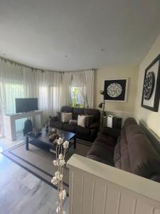 a living room with a couch and a table at Golden Beach in Marbella