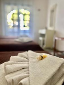 a banana sitting on top of towels on a bed at Blue Garden Inn in Fourka