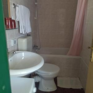 a bathroom with a sink and a toilet and a tub at Apartment Tuja in Jadrtovac