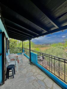 a balcony of a house with a table and chairs at Blue Garden Inn in Fourka +61 photos