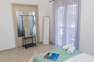 a bedroom with a bed and a mirror in a room at Cozy Central Home Heraklion in Heraklio Town