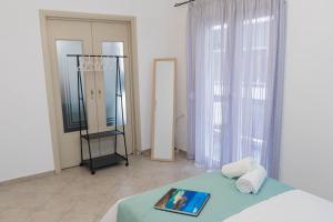 a bedroom with a bed and a mirror in a room at Cozy Central Home Heraklion in Heraklio