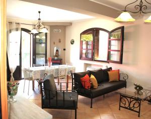 a living room with a couch and a table at Casa Vacanze A Ravà in Francavilla di Sicilia