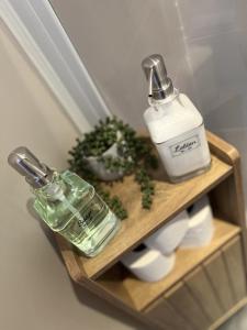 a shelf with a bottle of soap and a plant at The Crewe Arms in Hinton in the Hedges