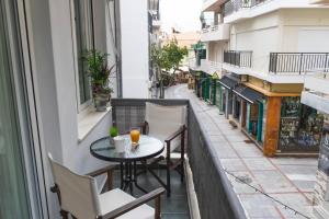 an apartment balcony with a table and chairs at Cozy Central Home Heraklion in Heraklio