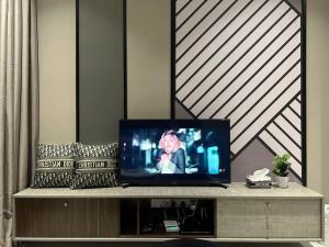 a flat screen tv sitting on top of a entertainment center at KL Luxury Family Suite 2Bedroom 2Bathroom in Kuala Lumpur