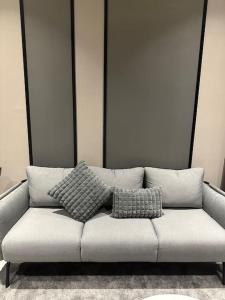 a couch with two pillows on it in a room at KL Luxury Family Suite 2Bedroom 2Bathroom in Kuala Lumpur