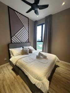 a bedroom with a bed with a ceiling fan at KL Luxury Family Suite 2Bedroom 2Bathroom in Kuala Lumpur
