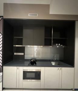 a kitchen with a sink and a stove top oven at KL Luxury Family Suite 2Bedroom 2Bathroom in Kuala Lumpur