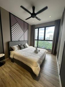 a bedroom with a large bed with a ceiling fan at KL Luxury Family Suite 2Bedroom 2Bathroom in Kuala Lumpur