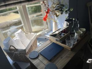 a table with a basket of towels and a window at The Crewe Arms in Hinton in the Hedges