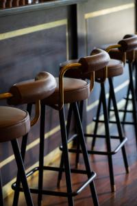 a row of bar stools sitting in a room at Tulfarris Hotel and Golf Resort in Blessington