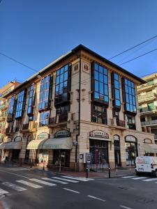 a large building on the corner of a street at CASA ODELLO suite and the sea in Bordighera