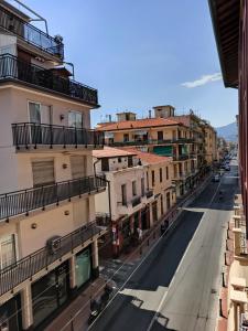 an empty street in a city with buildings at CASA ODELLO suite and the sea in Bordighera
