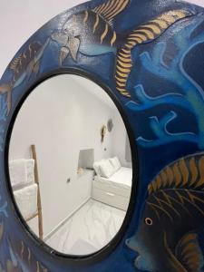 a mirror in a room with a painting on the wall at reAdy studio in Skiathos