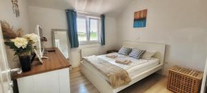 a bedroom with a bed and a desk and a window at Villa Valentina Nin in Ninski Stanovi +45 photos