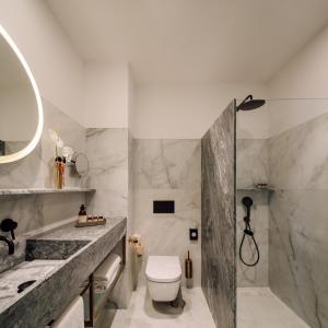 a bathroom with a sink and a toilet and a shower at Hotel Hotel - Member of Design Hotels in Lisbon