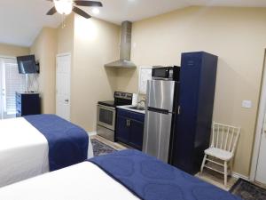 a small kitchen with a refrigerator and a stove at Rainbow Courts in Rockdale