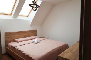 a bedroom with a bed with a teddy bear on it at Villa Ozoni - Jezerc in Ferizaj +20 photos