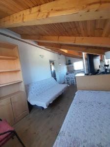 sypialnia z łóżkiem w pokoju z drewnianym sufitem w obiekcie Apartman Kolona w mieście Tkon