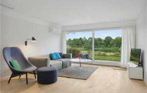 a living room with a couch and a window at Cozy Home In Niv With Kitchen in Nivå