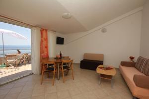 a living room with a couch and a table at Apartments Adriatika in Makarska