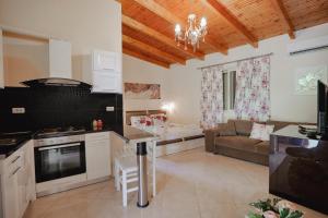 a kitchen and living room with a couch and a table at Villa Matilda in Borsh