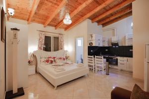 a living room with a white couch and a kitchen at Villa Matilda in Borsh
