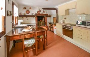 a kitchen with a wooden table and a counter top at Nice Home In Lusiana With Kitchen in Lusiana