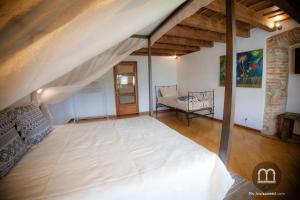 ein großes Zimmer mit einem großen Bett und einer Couch in der Unterkunft Namastè Apartment Città Alta with hills view in Bergamo