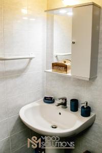 a white sink in a bathroom with a cabinet at Pefkohori Pegasus MoodSolutions Living in Pefkohori +24 photos